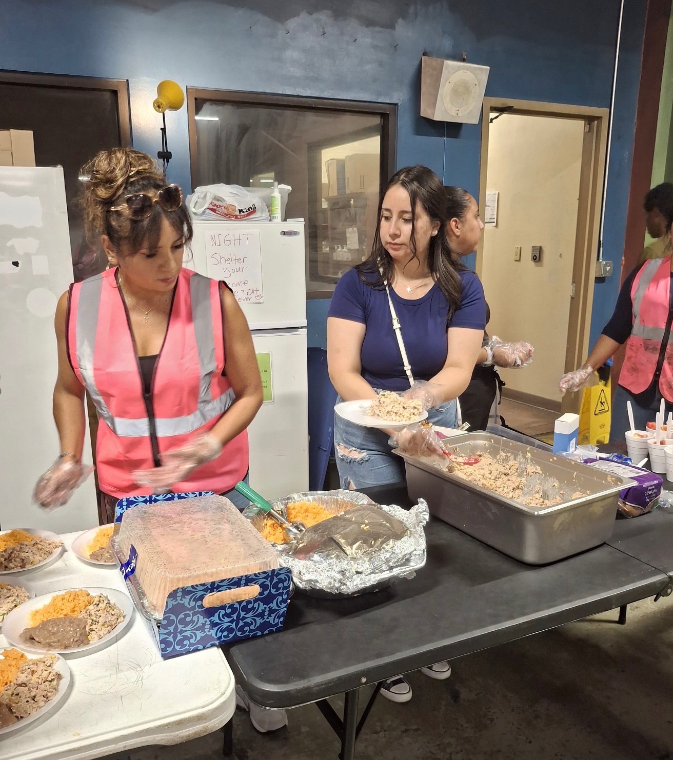 Volunteers plating meals in the kitchen