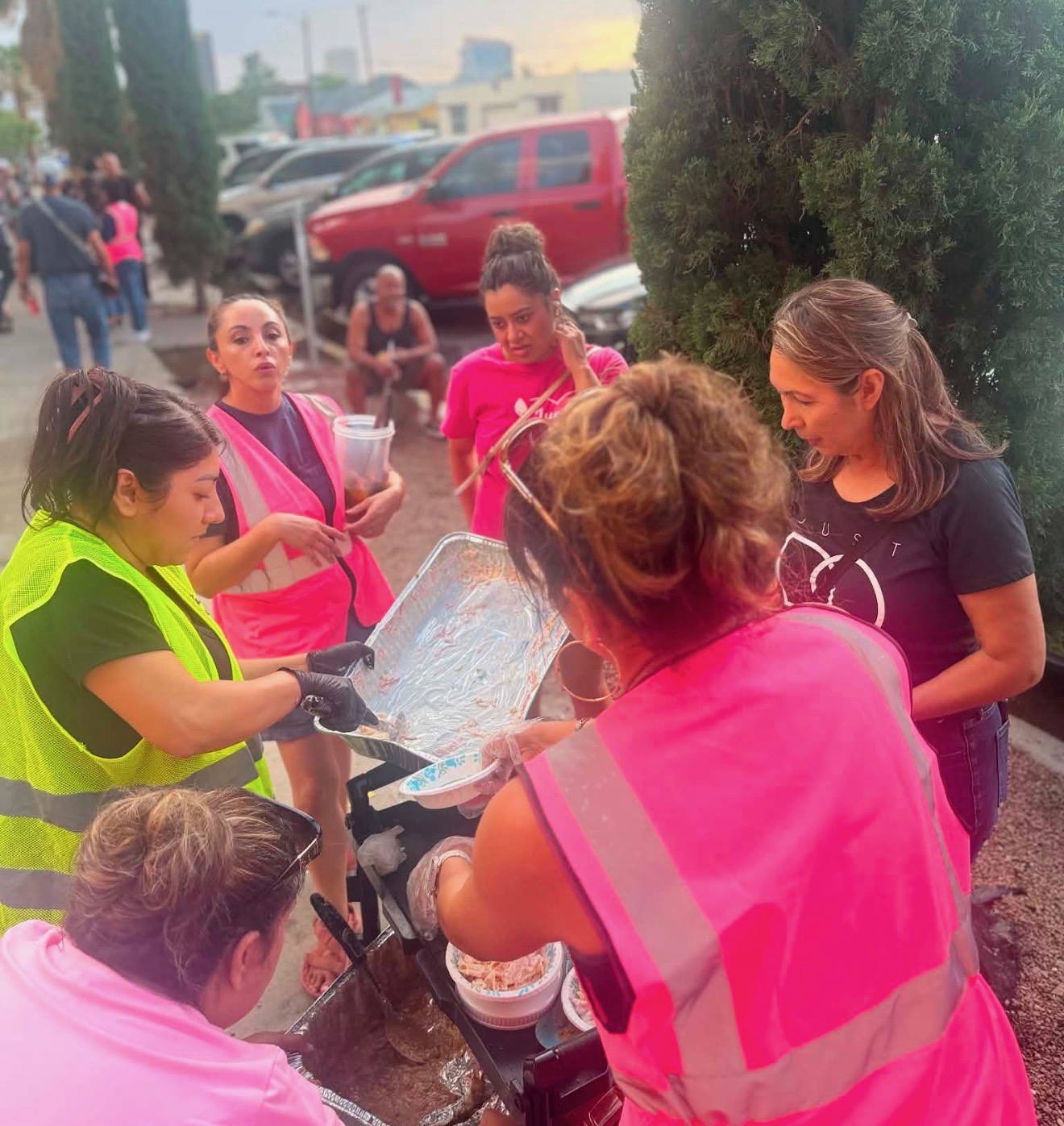 Volunteers gathered around a tray of food